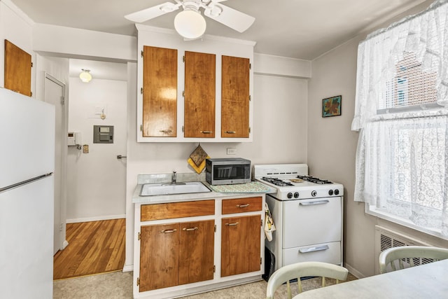 2390 Palisade Ave Unit 5J, Bronx, NY 10463 - kitchen featuring white appliances, light countertops, brown cabinets, and plenty of natural light