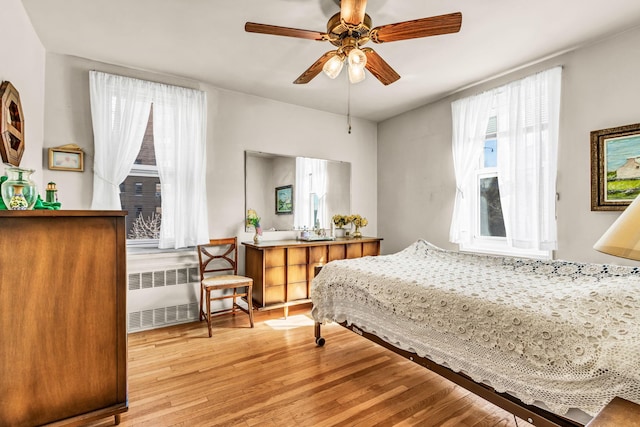 2390 Palisade Ave Unit 5J, Bronx, NY 10463 - bedroom with radiator heating unit, wood finished floors, and a ceiling fan