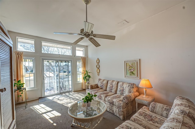 carpeted living area featuring ceiling fan