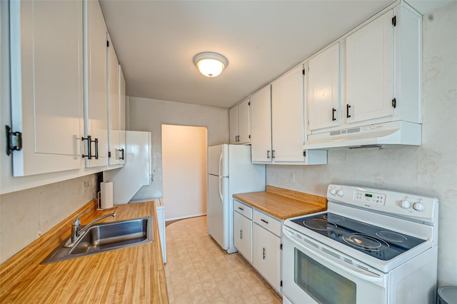 kitchen with white appliances, under cabinet range hood, white cabinets, and a sink