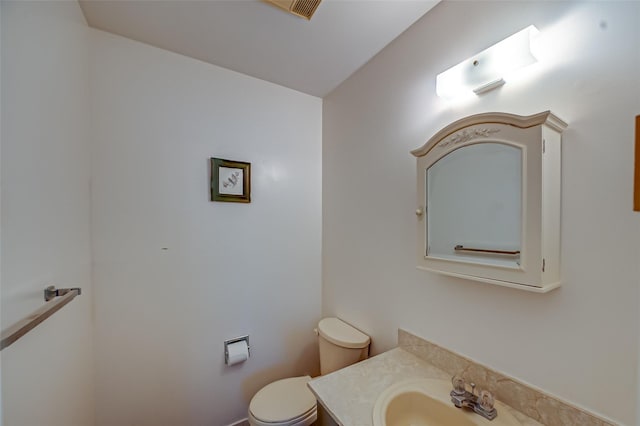 bathroom featuring toilet and vanity