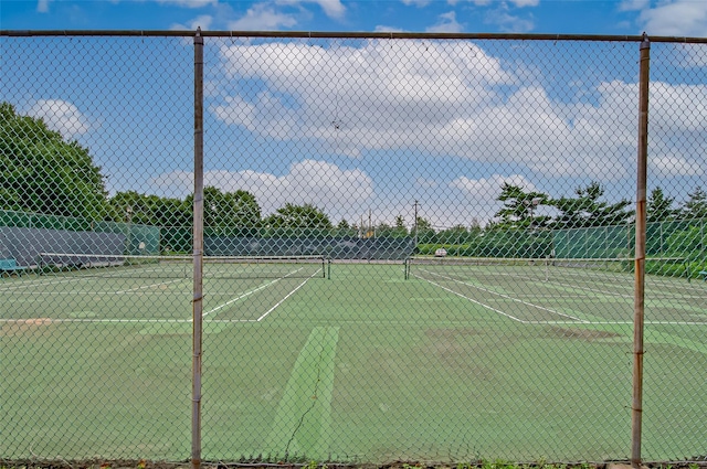 view of tennis court with fence