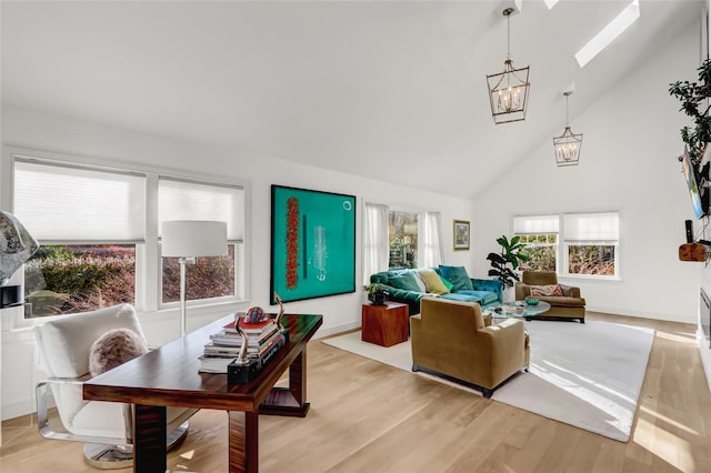 12 Bob White Dr, Water Mill, NY 11976 - living room featuring a skylight, baseboards, a chandelier, light wood-style floors, and high vaulted ceiling