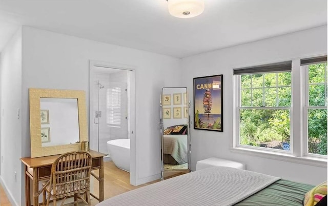 12 Bob White Dr, Water Mill, NY 11976 - bedroom with multiple windows, light wood-style flooring, and ensuite bath