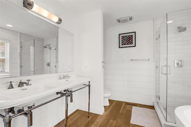 12 Bob White Dr, Water Mill, NY 11976 - full bathroom with visible vents, a shower stall, toilet, and wood finished floors