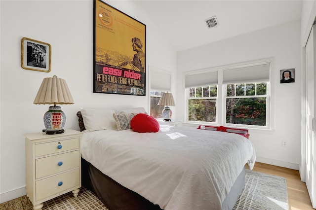12 Bob White Dr, Water Mill, NY 11976 - bedroom featuring light wood finished floors, baseboards, visible vents, and vaulted ceiling