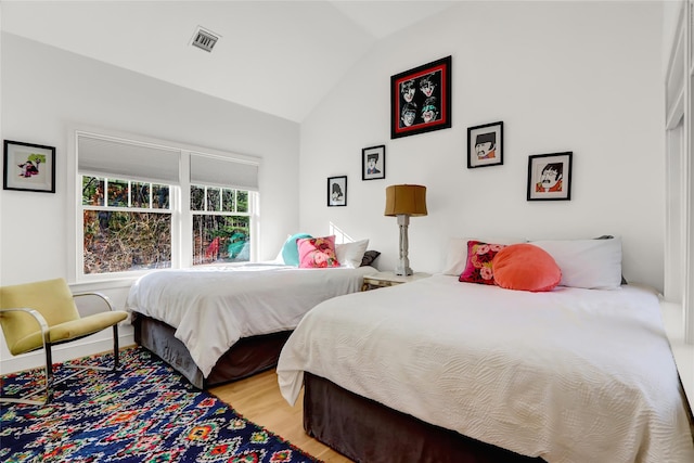 12 Bob White Dr, Water Mill, NY 11976 - bedroom with lofted ceiling, light wood-type flooring, and visible vents
