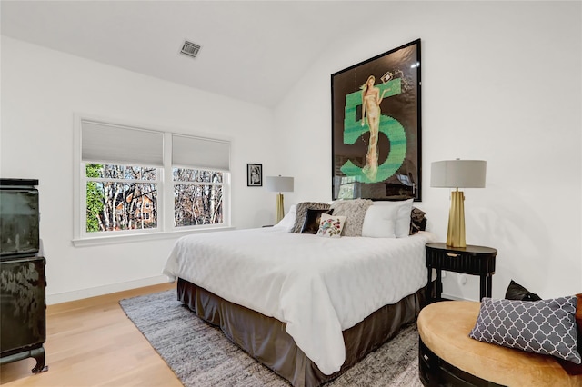 12 Bob White Dr, Water Mill, NY 11976 - bedroom featuring lofted ceiling, baseboards, visible vents, and wood finished floors
