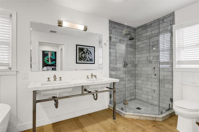 12 Bob White Dr, Water Mill, NY 11976 - full bathroom featuring double vanity, toilet, a sink, a shower stall, and wood finished floors