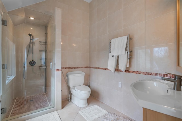 full bath with tile walls, toilet, tile patterned floors, and a shower stall