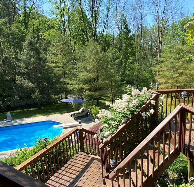 outdoor pool featuring a deck and a patio