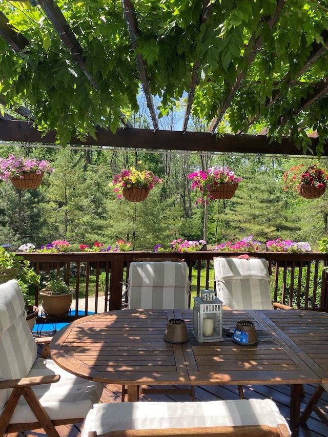 wooden terrace featuring outdoor dining area