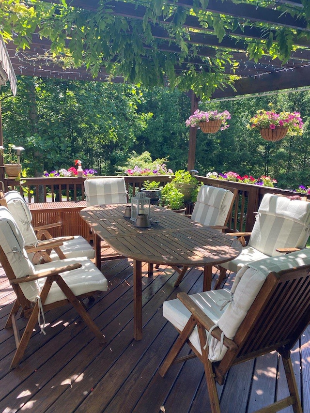 wooden terrace featuring outdoor dining space