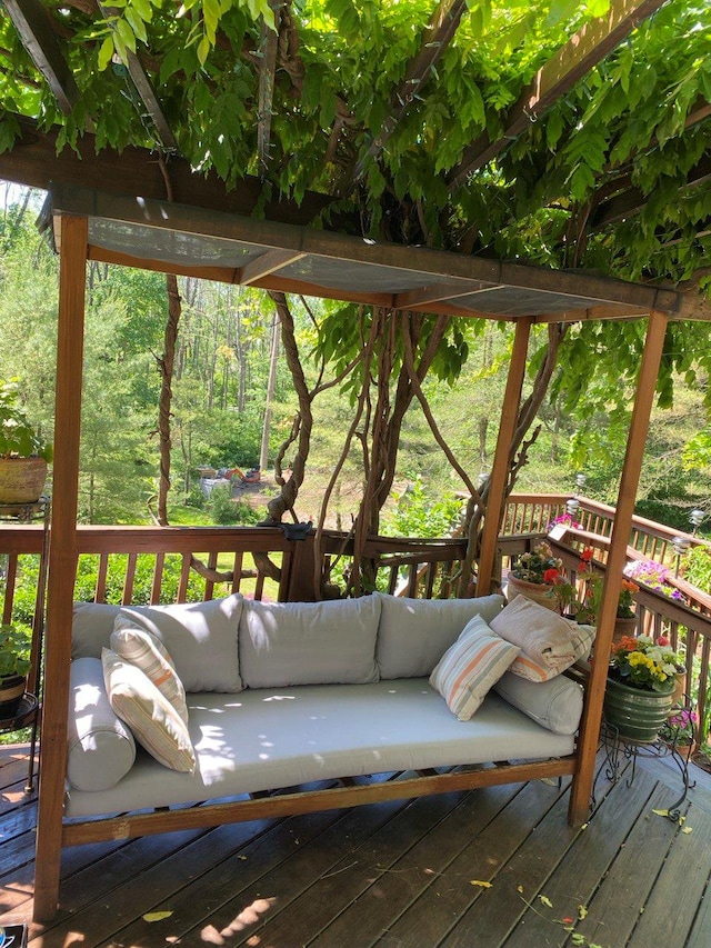 deck featuring a wooded view and outdoor lounge area