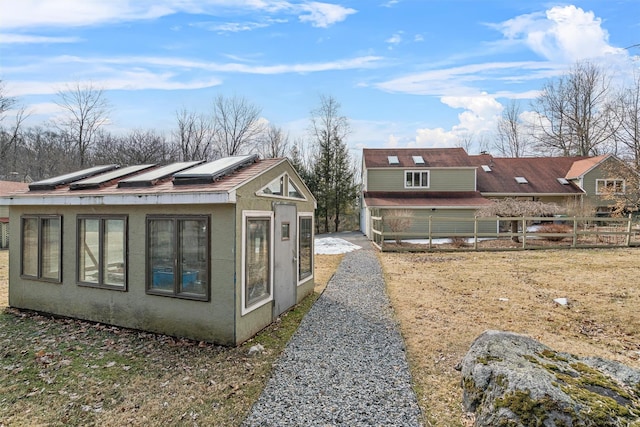 view of home's exterior with fence and stucco siding