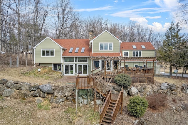 rear view of property with a chimney, a pergola, stairs, and a deck