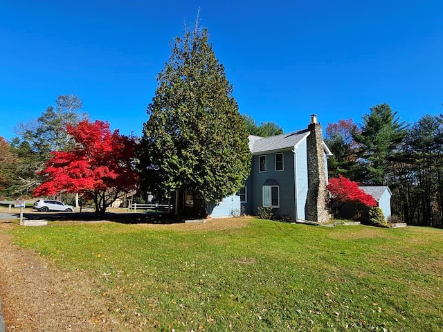 view of property exterior featuring a yard and a chimney