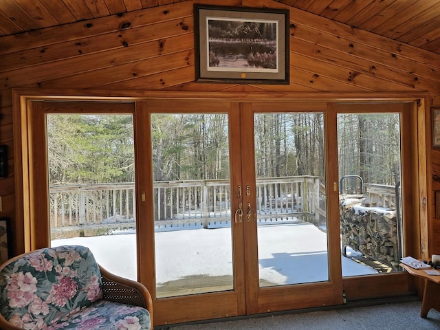 doorway to outside with french doors, wooden ceiling, and carpet flooring