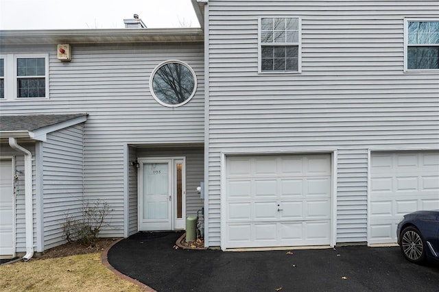 view of front of property with aphalt driveway and an attached garage