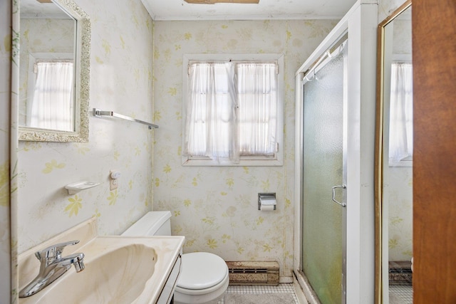 full bathroom with vanity, a shower stall, toilet, and wallpapered walls