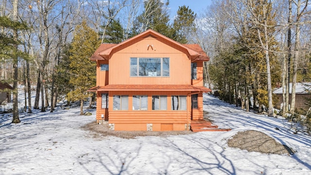 chalet / cabin with a shingled roof and crawl space