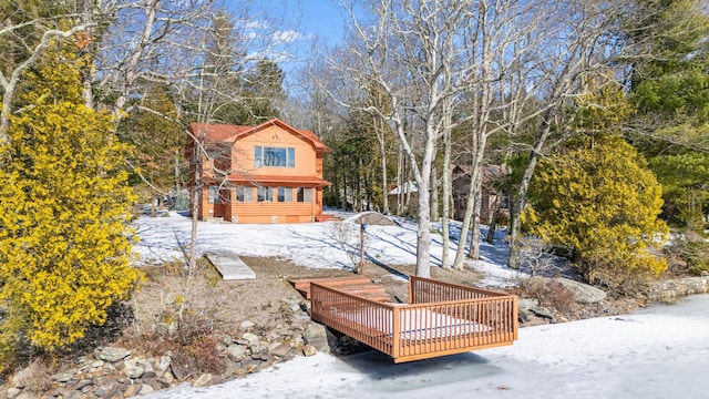 yard layered in snow featuring a wooden deck