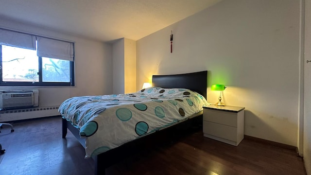 bedroom featuring baseboards, lofted ceiling, a baseboard radiator, wood finished floors, and a wall mounted AC