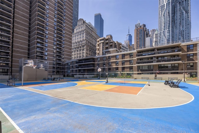 view of sport court with a city view, community basketball court, and fence
