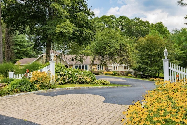 view of community with fence and driveway