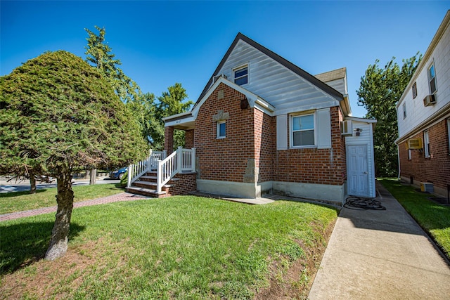 bungalow-style home with brick siding and a front lawn