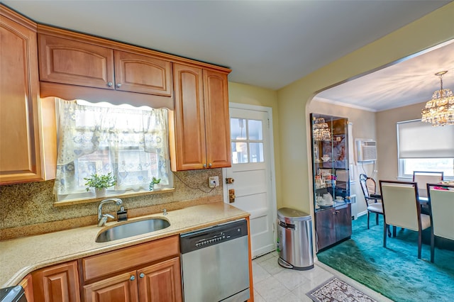 kitchen with a wall unit AC, light countertops, decorative backsplash, a sink, and dishwasher