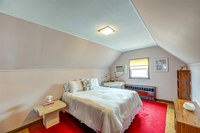 bedroom featuring lofted ceiling, radiator heating unit, baseboards, and an AC wall unit