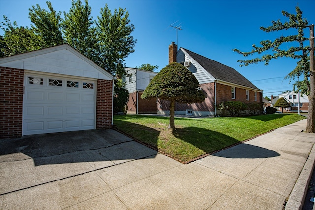 view of side of home with an outbuilding, driveway, a yard, and brick siding