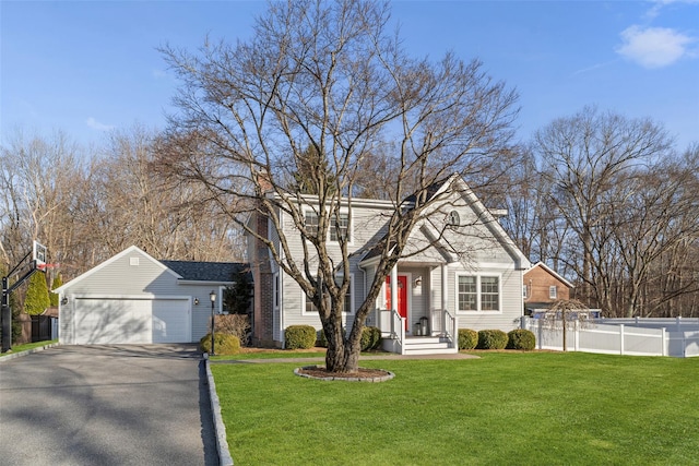 view of front of property featuring a garage, a chimney, fence, and a front yard