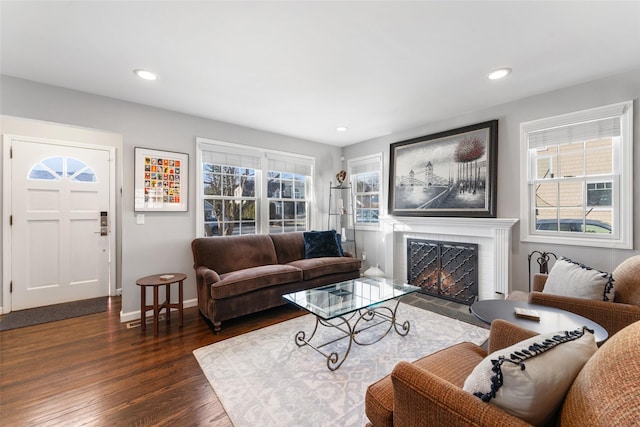 living room with recessed lighting, a fireplace, dark wood finished floors, and a healthy amount of sunlight