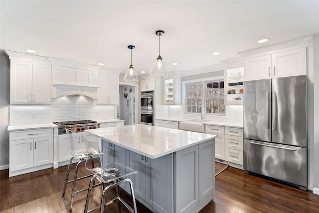 kitchen with appliances with stainless steel finishes, a sink, and white cabinets