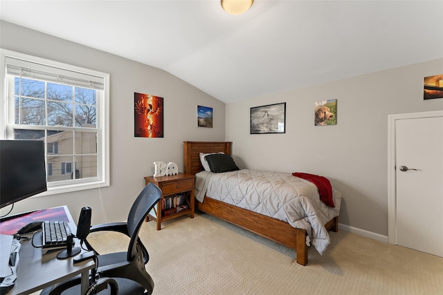 bedroom featuring lofted ceiling, light carpet, and baseboards