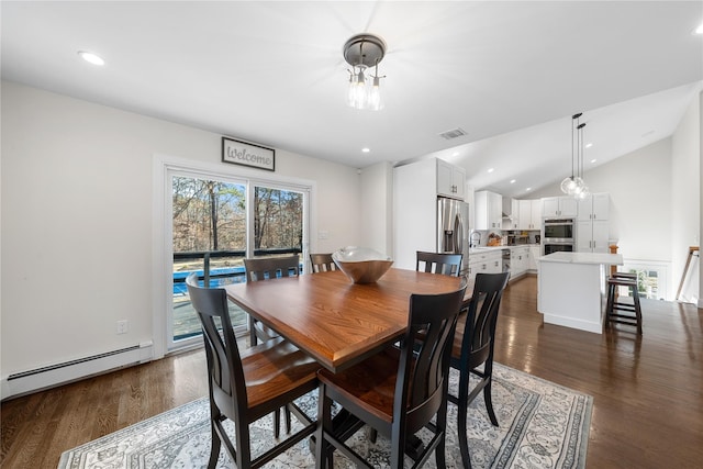 dining room featuring vaulted ceiling, visible vents, baseboard heating, and dark wood-style flooring