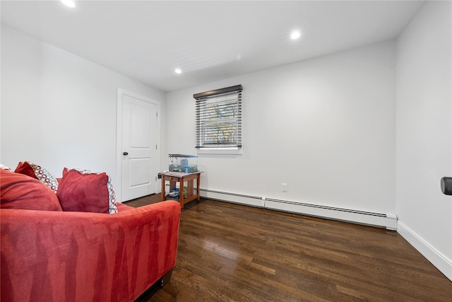 sitting room featuring baseboards, baseboard heating, wood finished floors, and recessed lighting