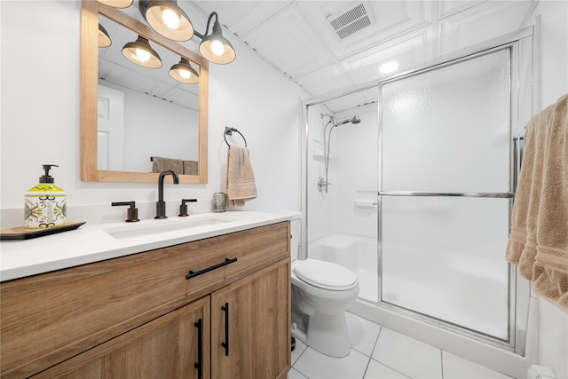 bathroom with visible vents, toilet, vanity, a shower stall, and tile patterned floors