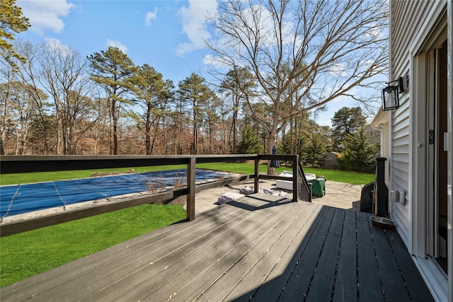 deck with a covered pool and a lawn