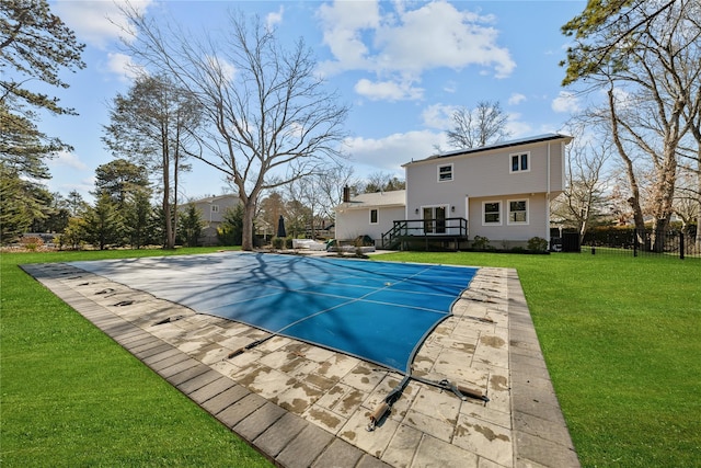 view of pool featuring a fenced in pool, a yard, a wooden deck, and fence