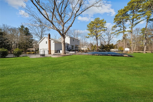 view of yard featuring an outdoor fire pit, fence, and a patio