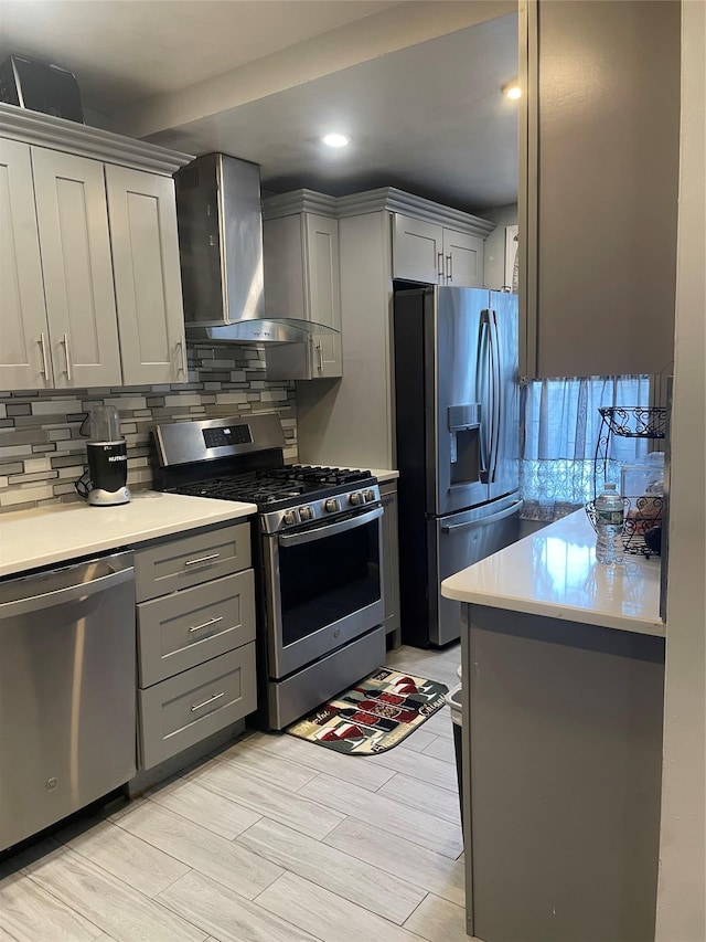 113-21 203rd St, Saint Albans, NY 11412 - kitchen featuring appliances with stainless steel finishes, gray cabinets, wall chimney range hood, tasteful backsplash, and recessed lighting