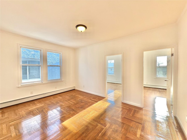 empty room with baseboards and a baseboard heating unit