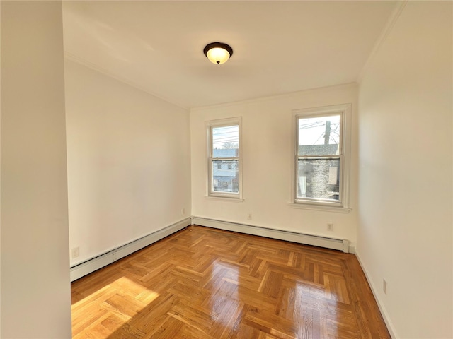 unfurnished room featuring a baseboard heating unit and baseboards