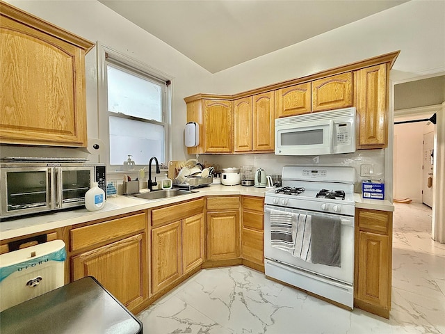 kitchen with white appliances, marble finish floor, light countertops, and a sink