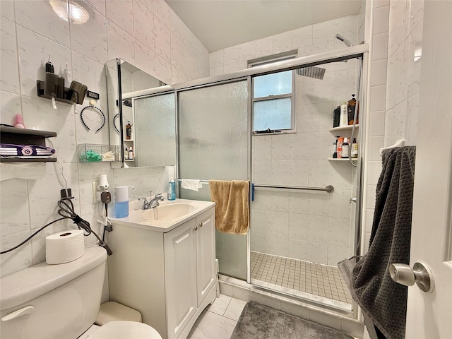 full bath featuring toilet, a shower stall, tile walls, and vanity