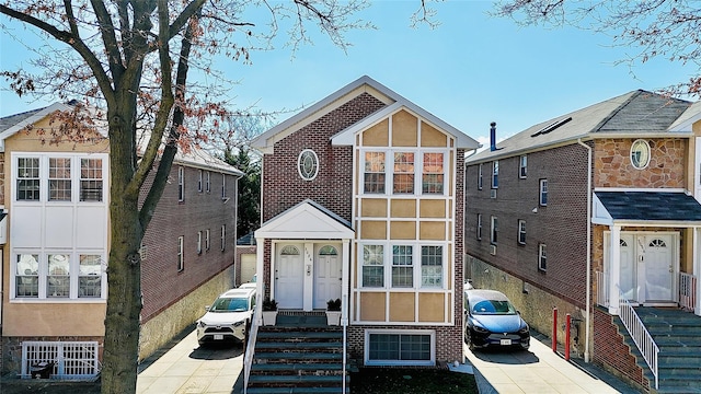 view of front facade with brick siding and stucco siding