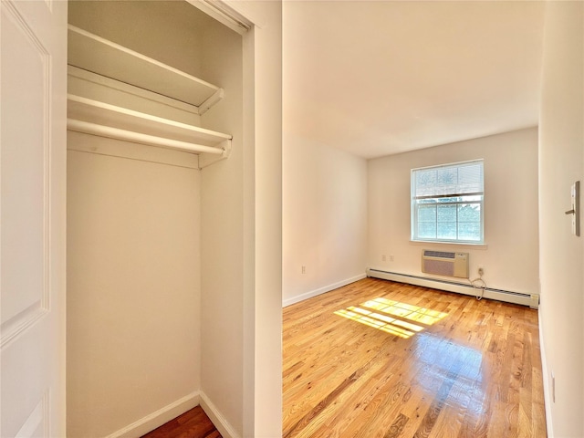 closet with a baseboard radiator and a wall mounted AC